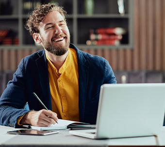 Smiling Professional Working On Laptop