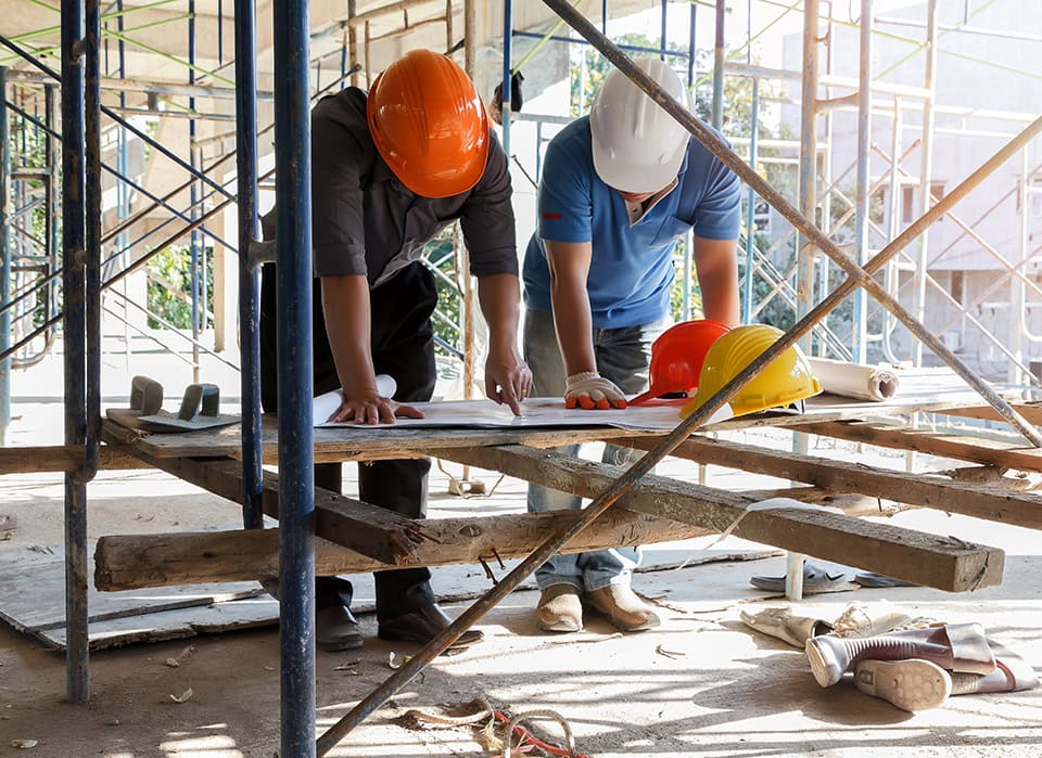 Construction Managers Reviewing Building Plans