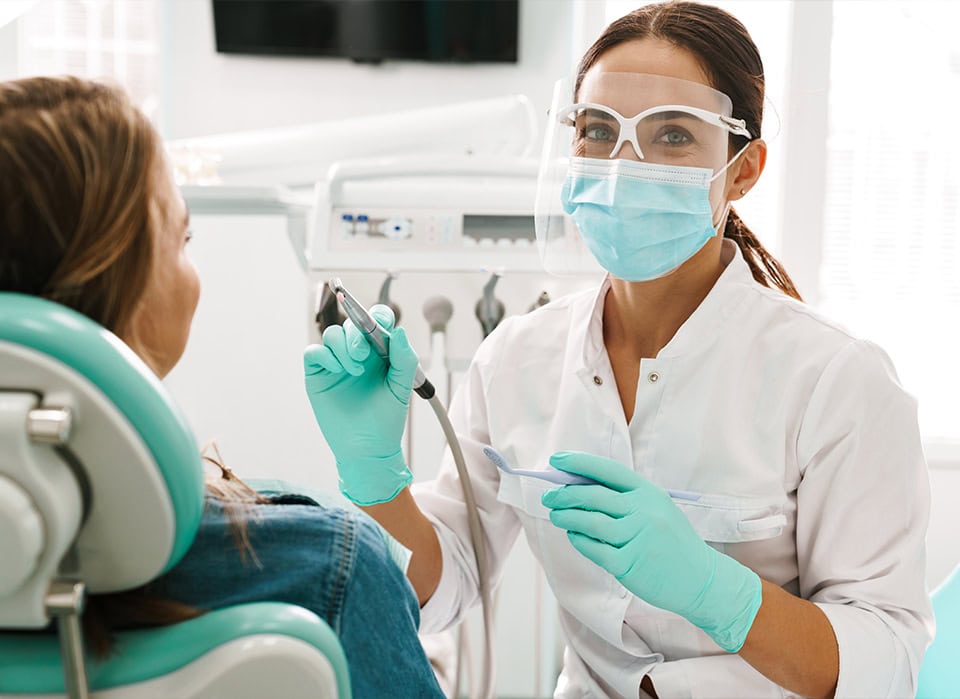 Dentist Performing Patient Dental Exam