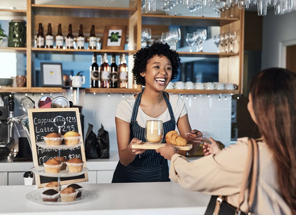 Local Cafe Owner Serving Customer