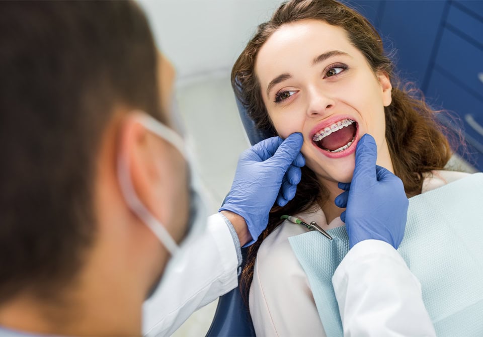 Orthodontist Checking Patient Braces